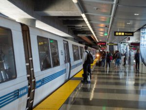 BART bay area rapid transit train with passengers boarding at SFO stop stock photo